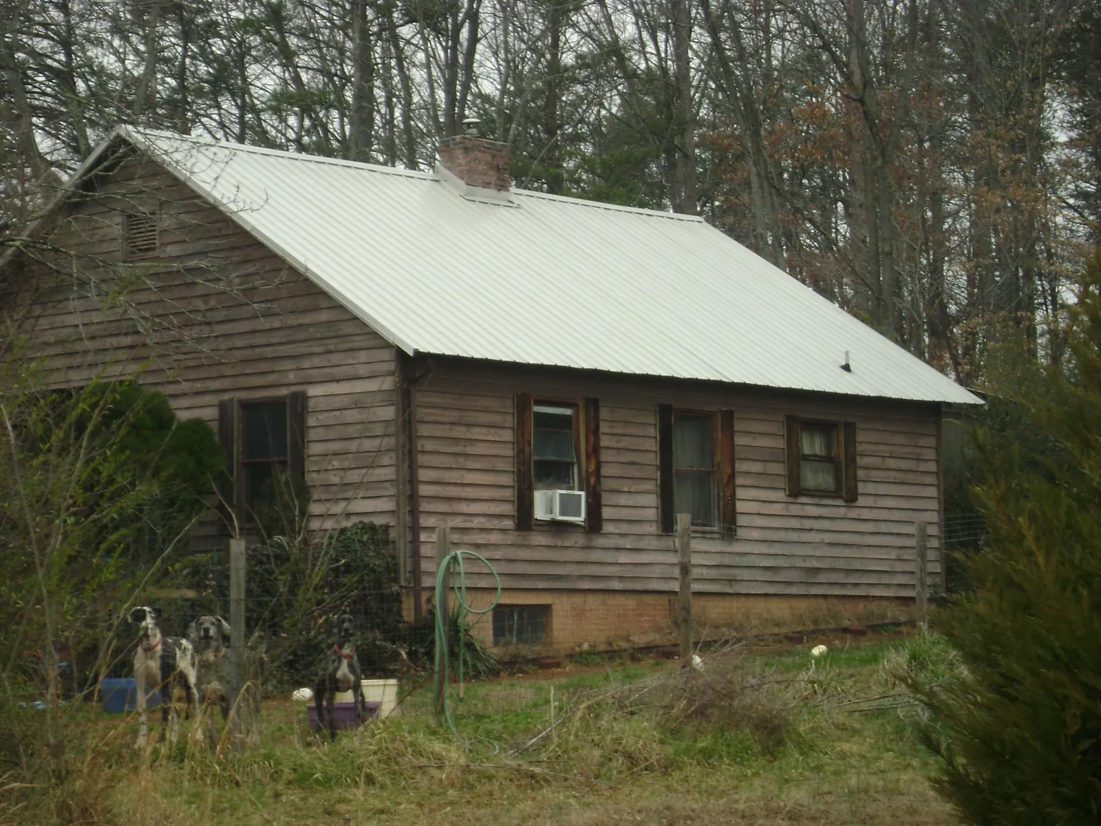 White metal roof on an old wood sided farmhouse, from a Metal Roof Installation job in Eastford